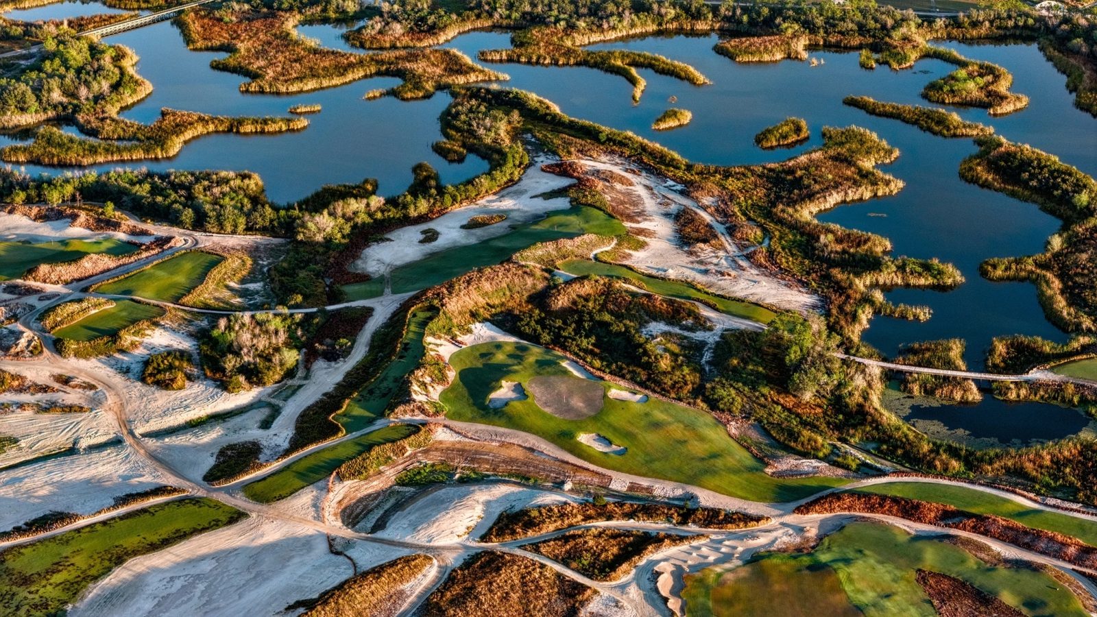 Aerial view of Streamsong Bone Valley golf course with dramatic sandy dunes, wetlands, and lakes carved into the phosphate mining terrain in central Florida